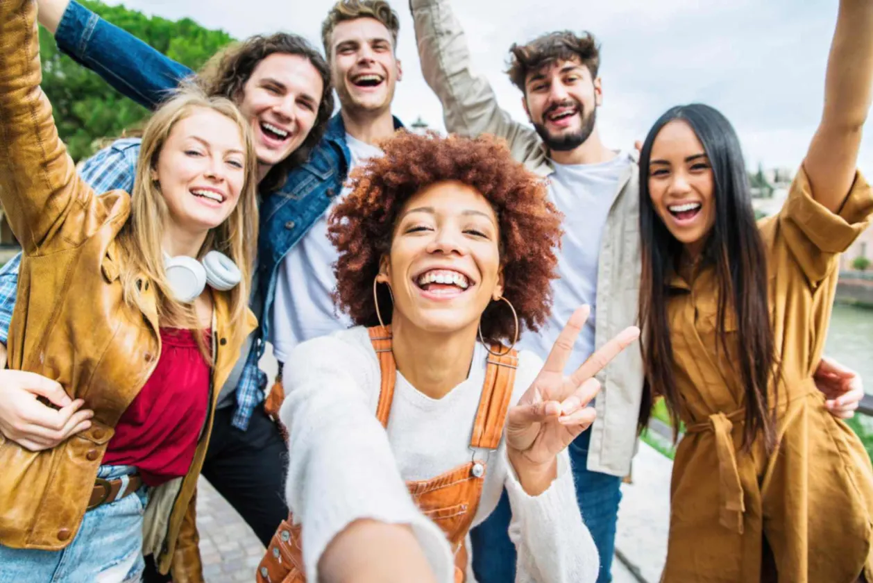Group of Gen Z travelers taking selfie